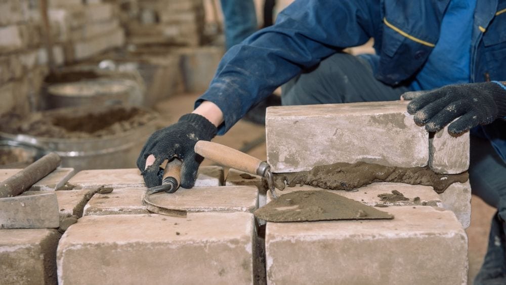 Man laying brick