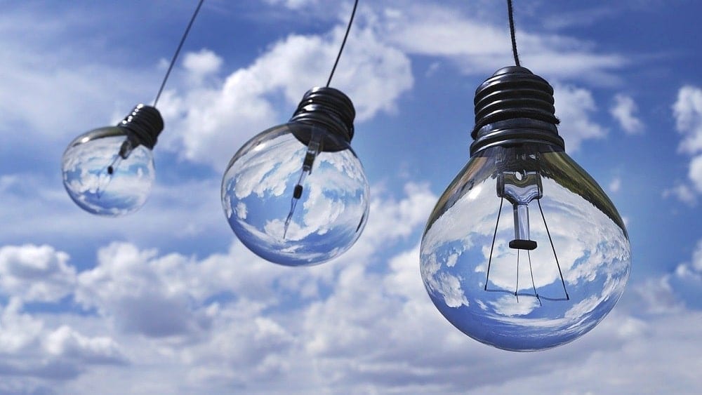 Light bulbs hanging outside against a blue sky background.