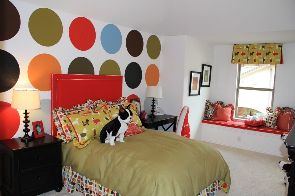 Polka dots painted on one wall make a distinctive room for a young girl. 