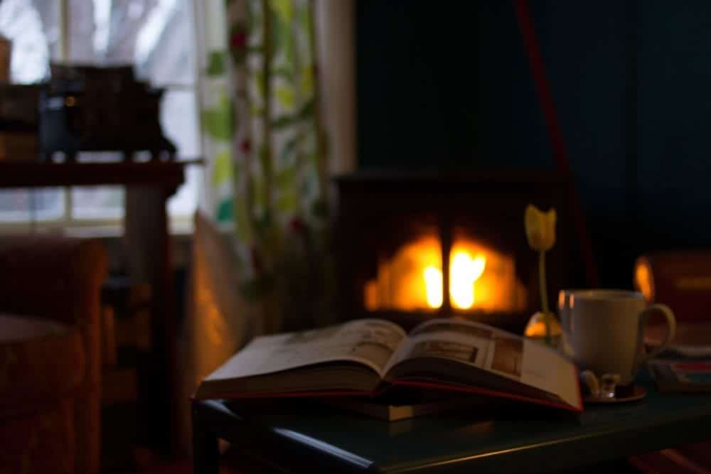 A book in front of a fireplace