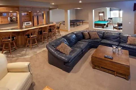Finished basement made into living area with kitchen and dining area, lounging area and rec area.