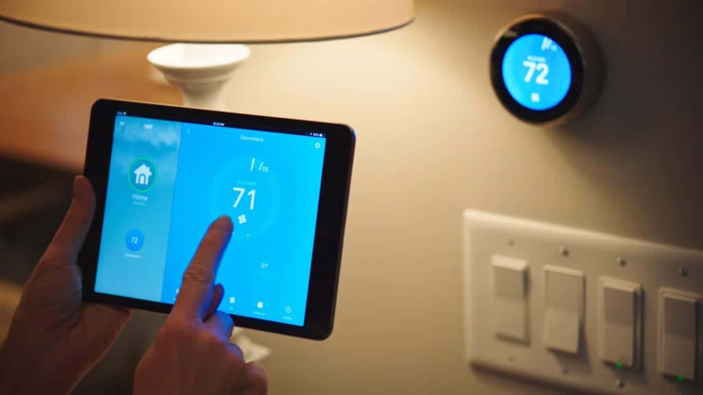 Home owner cools their home from their iPad and a smart thermostat.