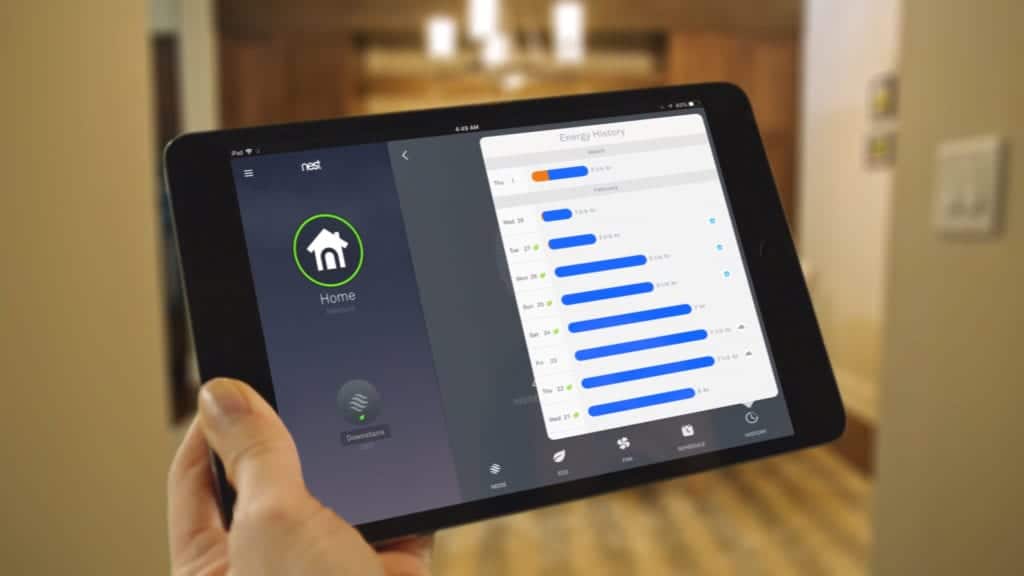 A homeowner sees their energy savings of their smart home on their iPad.