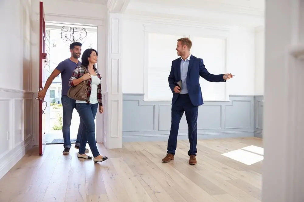 Realtor showing couple a new home interior