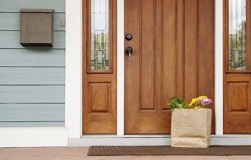 A beautiful bag of flowers on the doorstep of a custom home.