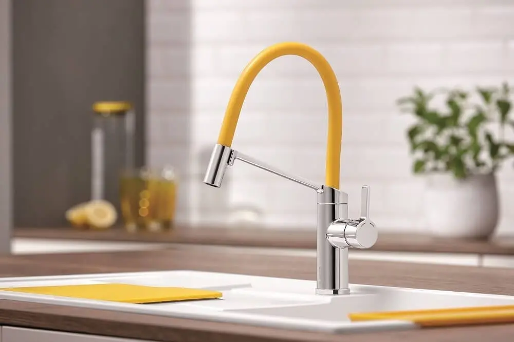 Yellow and silver kitchen sink faucet