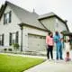 Family of four standing outside their home on the driveway