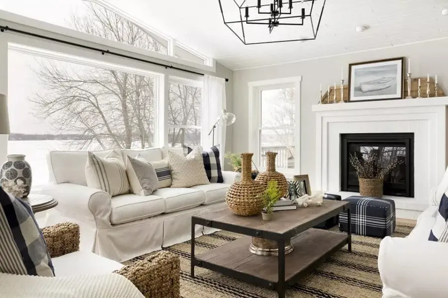 White living room with decor in a variety of textures including jute, wood, and linen
