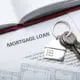 Set of house keys on top of mortgage loan files