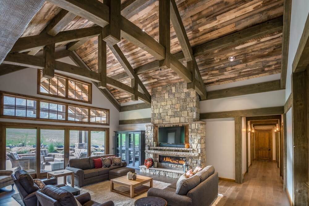 Ranch-style living room with lots of natural light coming in through windows and glass doors that lead to a patio