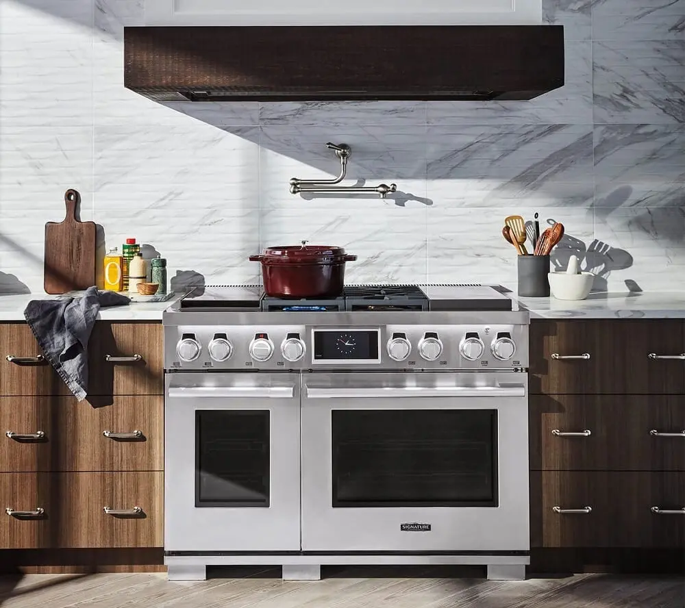 Modern kitchen featuring a silver pro range with built-in sous vide, induction, and gas on cooktop