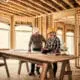 woman architect stands in-frame of custom home