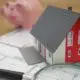 A house with on a loan with a piggy bank in the background