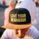 man wearing a love your neighbor hat