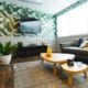 Comfy living room with banana leaf wallpaper.