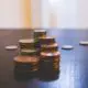 Close shot of stacks of coins on black table.
