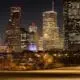 Downtown Houston high-rise buildings illuminated at night.