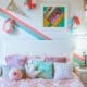 Kids bedroom with white furniture and blue and pink accent pieces.