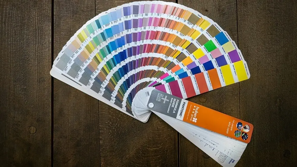 A wheel of paint chips against a dark wood background.