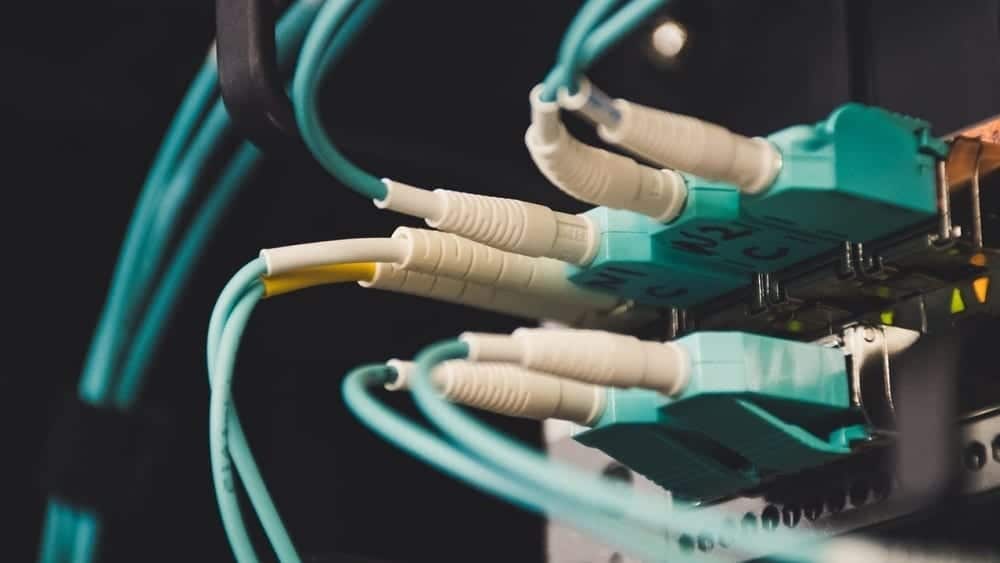 Close shot of teal and white cables plugged in a device.