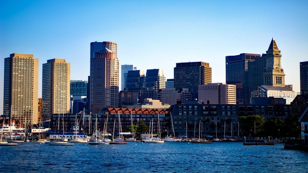View of Boston skyline from Boston Harbor with sailboats in foreground
