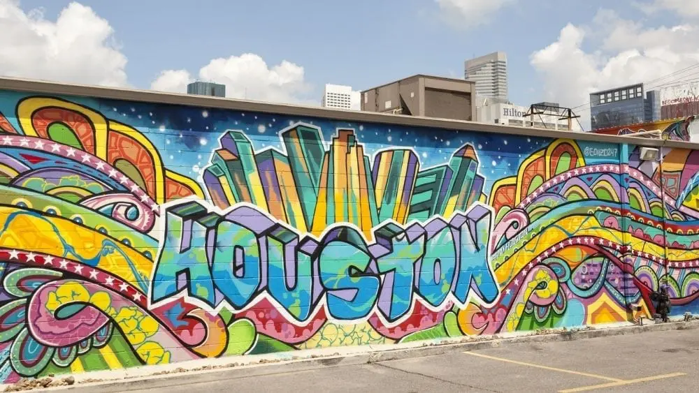 Colorful graffiti on the side of a building that reads "Houston" in blocky letters.
