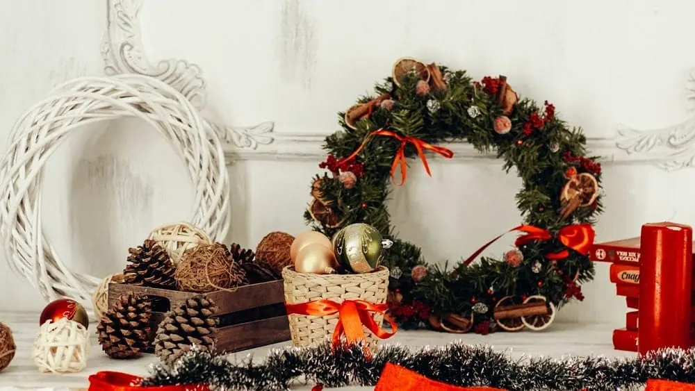Mantel with wreaths, garland, and baskets of ornaments and pine cones.