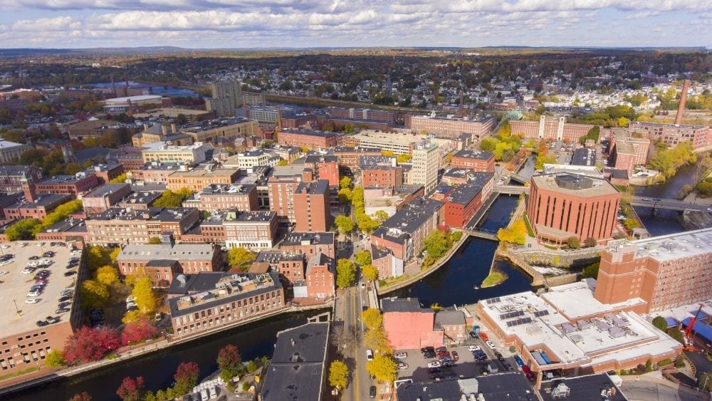 Aerial view of downtown Lowell with a river running through the city.