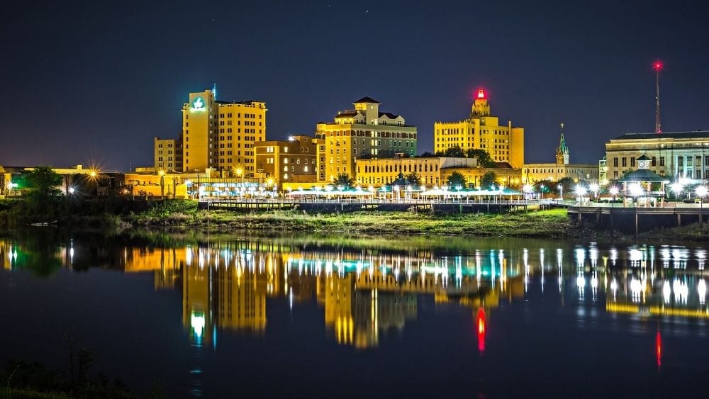 The skyline of Monroe, Louisiana at night from the water.