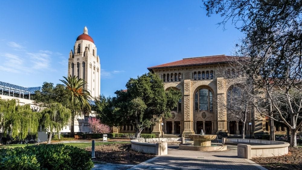 An administrative building and Hoover Tower on the University of Stanford's campus.