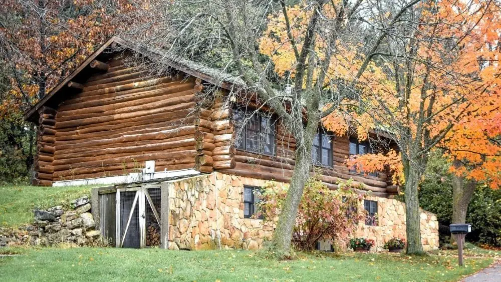 Log cabin with a stone foundation.