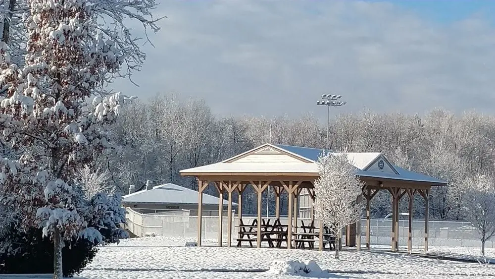 A gazebo in a park during winter.