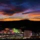 Skyline of Reno, Nevada with a dramatic sunset in the background.