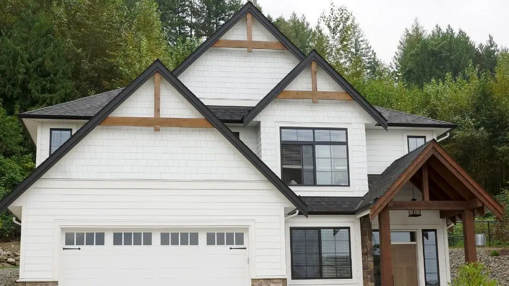 Simple two-story white house with wooden door, windows, and porch