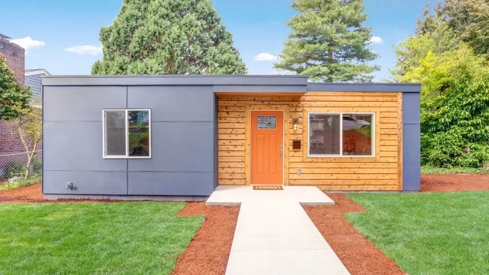 Modern rectangular home with mixed wood and metal siding.