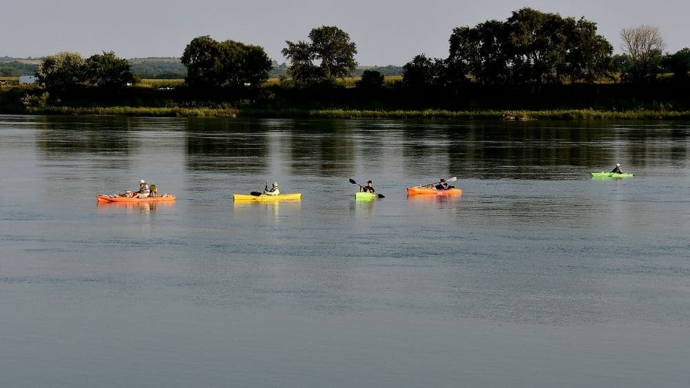 four kayakers on the missouri river in south dakota