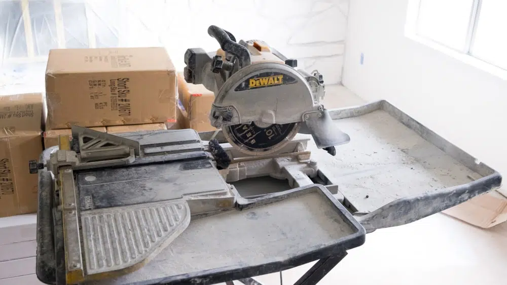 A circular saw and boxes of flooring materials for a living room renovation