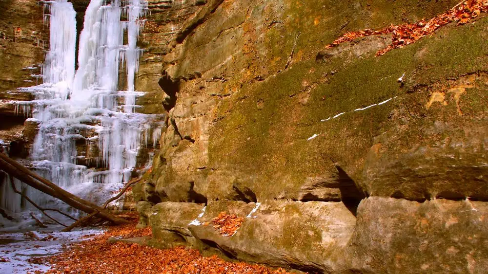 A frozen waterfall on a rockface.