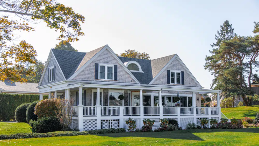 Large gray house with white porch.