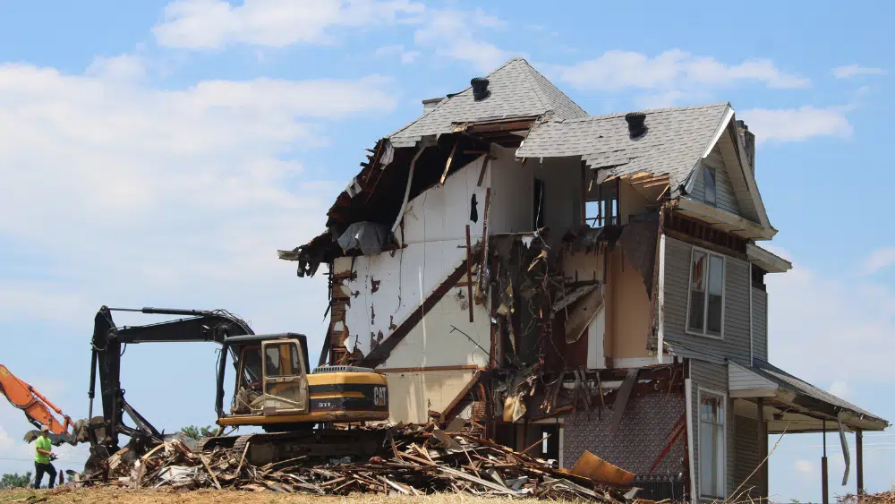 Exterior view of house being demolished.