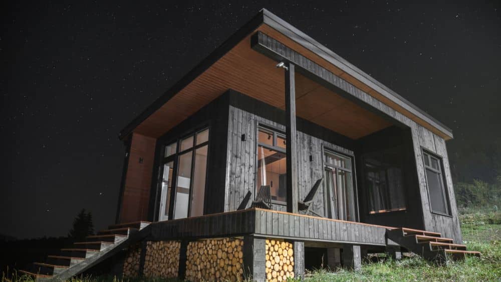 tiny home with deck black finished wood at night ohio