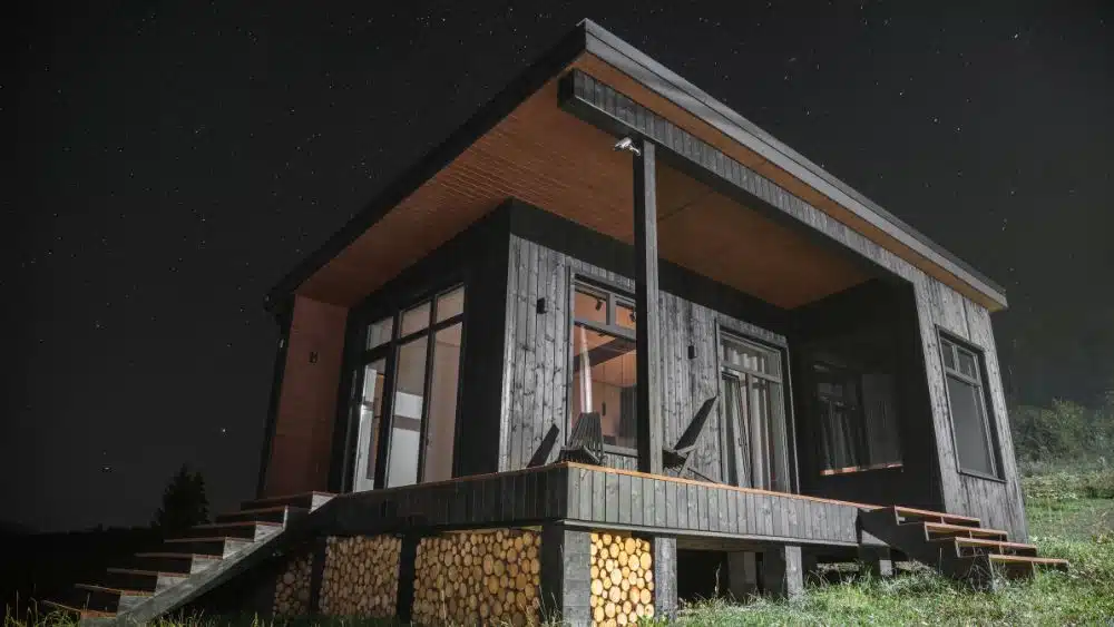 tiny home with deck black finished wood at night ohio