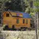 cozy rustic tiny home on wheels in the woods