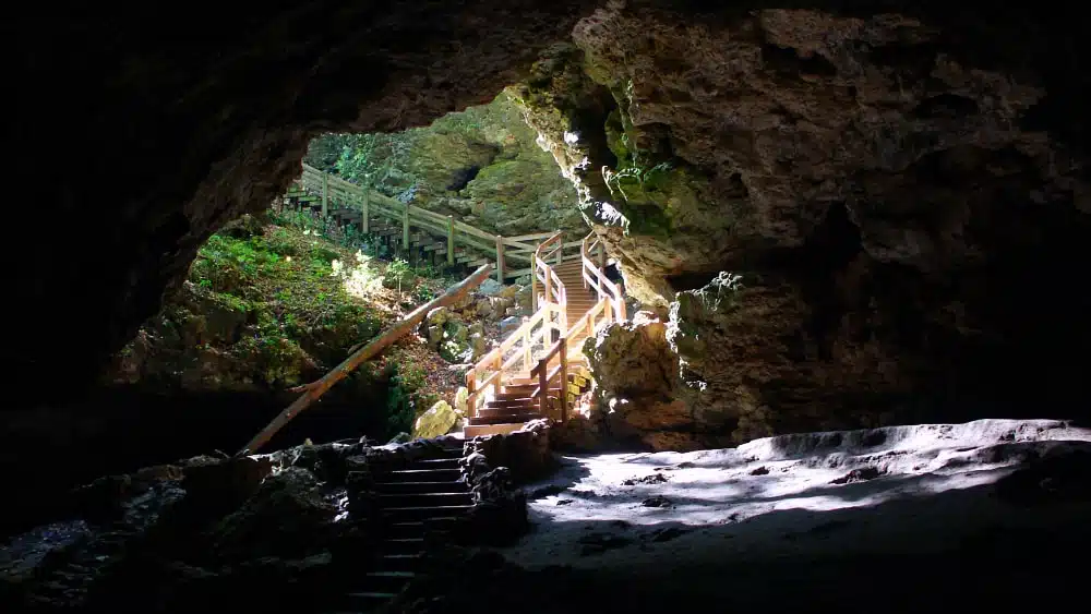 Maquoketa Caves State Park in Iowa with wooden staircase leading down into a cave
