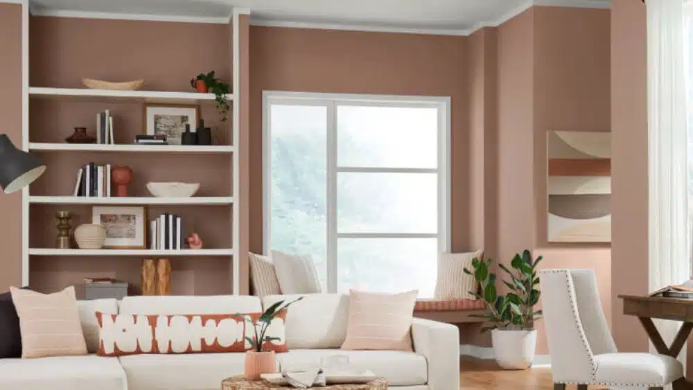 Living room with brown/pink walls and white accents.
