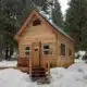 quaint rustic tiny home in the winter woods alaska
