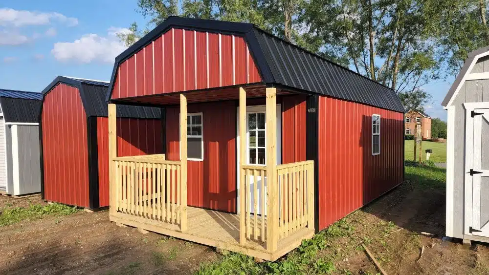 tiny home with gambrel roof and wooden deck