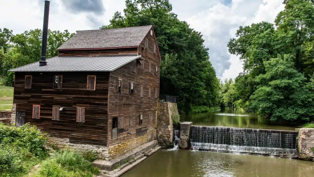 Historic grist mill with a small waterfall.