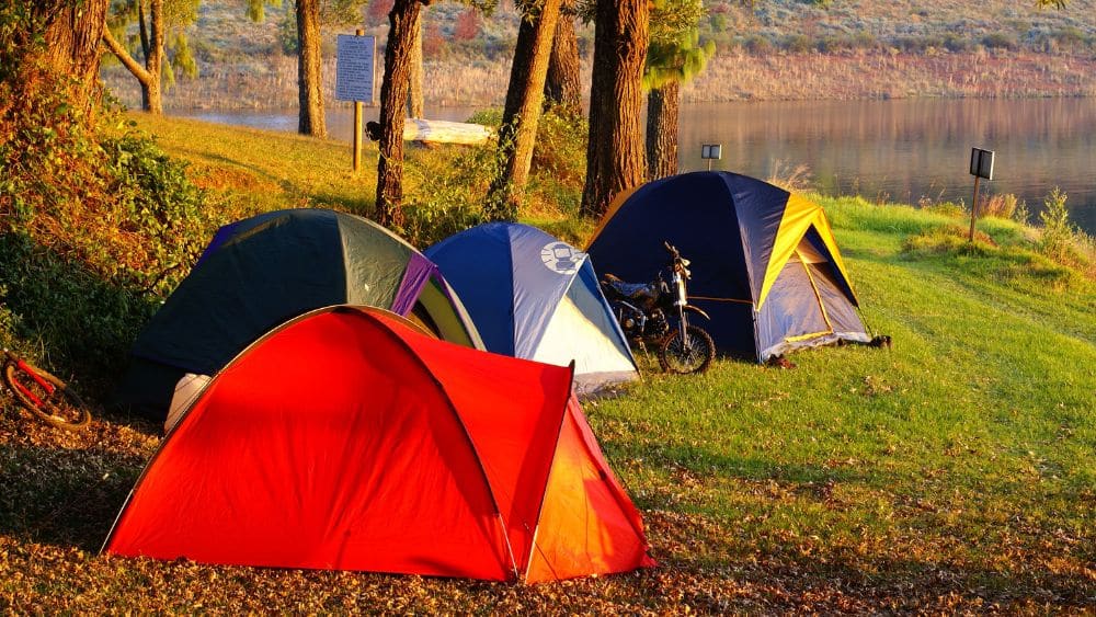 Camping tents on the banks of a river.