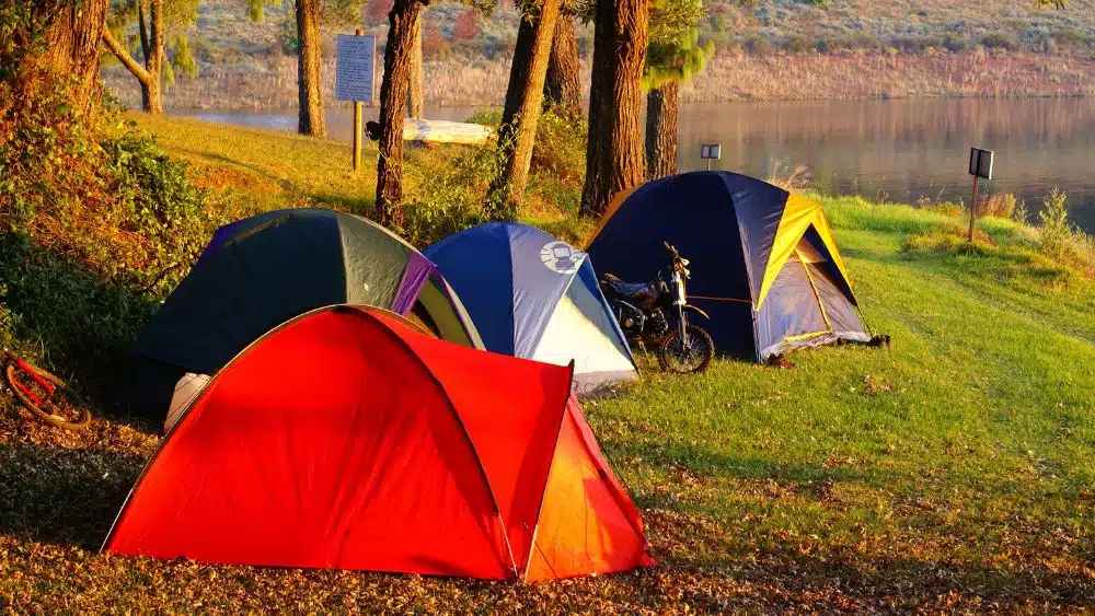 Camping tents on the banks of a river.